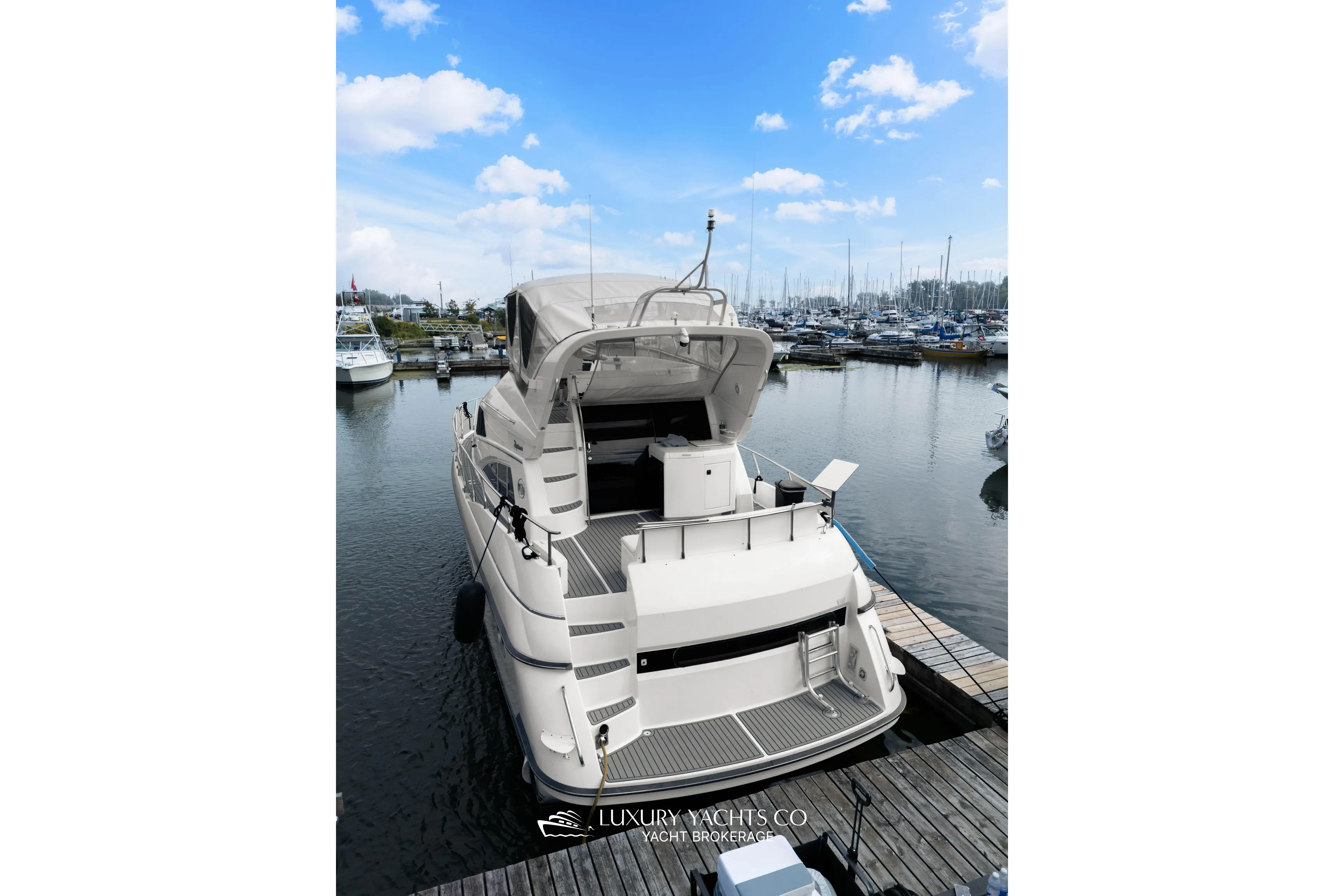  Yacht Photos Pics 1997 Neptunus 50 Aft Cabin yacht docked at marina under blue sky.
