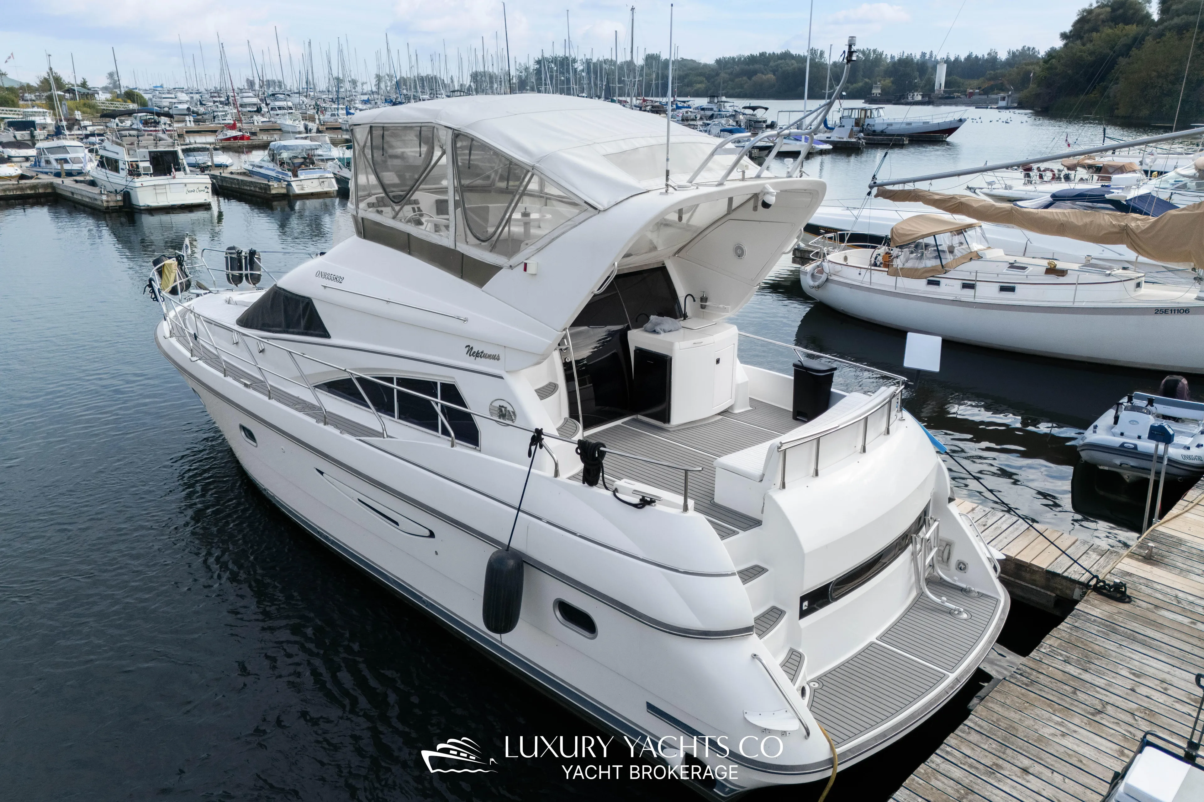  Yacht Photos Pics 1997 Neptunus 50 Aft Cabin yacht docked at marina, showcasing luxury design.