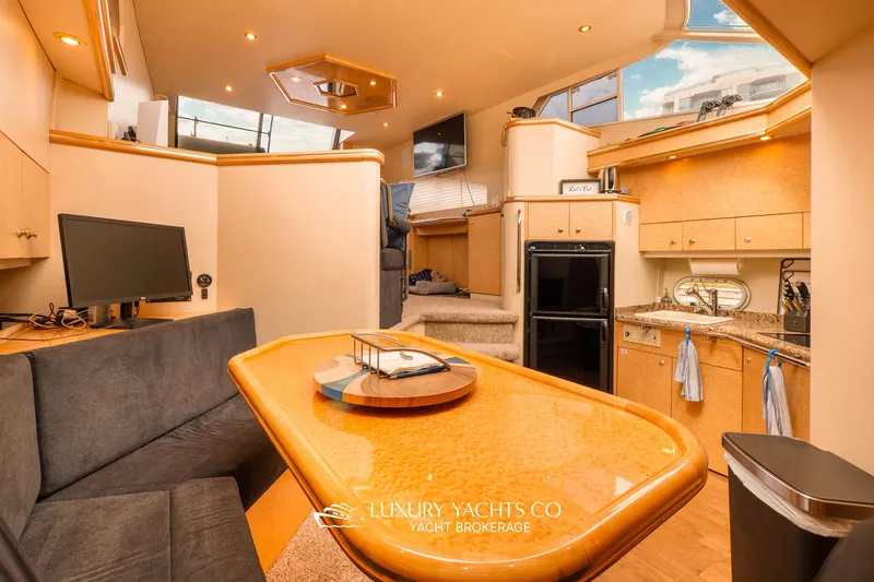 Yacht Photos Pics Luxurious 1997 Neptunus 50 Aft Cabin yacht interior with modern kitchen and seating area.