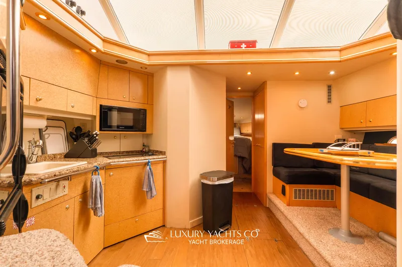  Yacht Photos Pics Luxurious 1997 Neptunus 50 Aft Cabin yacht interior with modern kitchen and dining area.