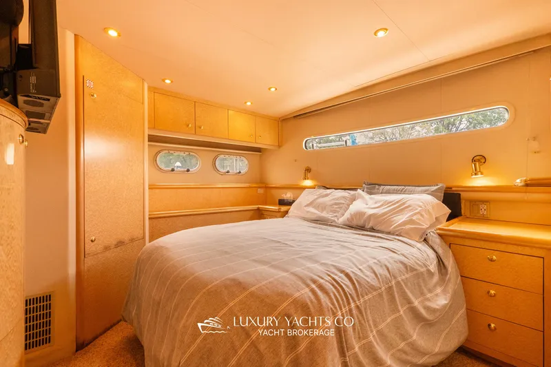  Yacht Photos Pics Luxurious 1997 Neptunus 50 Aft Cabin yacht bedroom with elegant wood finishes.