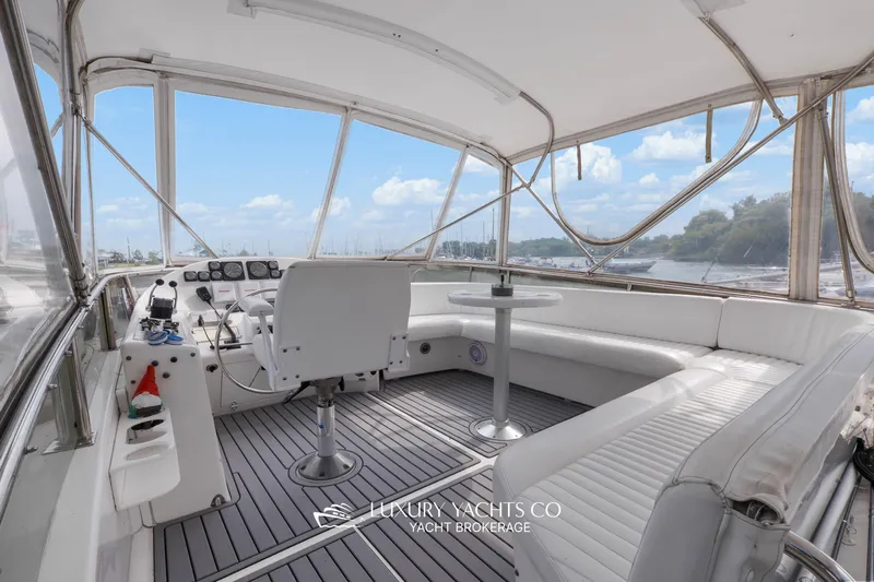  Yacht Photos Pics Luxurious 1997 Neptunus 50 Aft Cabin yacht interior with helm and seating area.