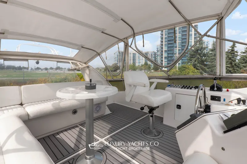  Yacht Photos Pics Luxurious 1997 Neptunus 50 Aft Cabin yacht interior with modern seating and control area.