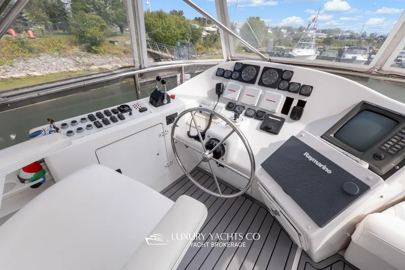  Yacht Photos Pics 1997 Neptunus 50 Aft Cabin yacht helm with steering wheel and navigation instruments.