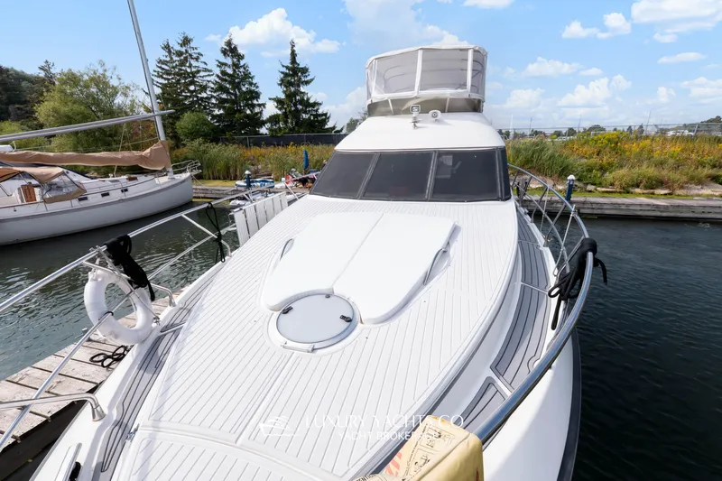  Yacht Photos Pics 1997 Neptunus 50 Aft Cabin yacht docked, showcasing sleek design and spacious deck.