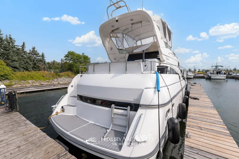 Yacht Photos Pics 1997 Neptunus 50 Aft Cabin yacht docked at marina under blue sky.