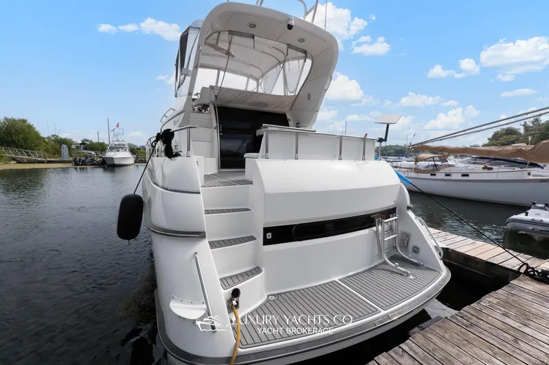  Yacht Photos Pics 1997 Neptunus 50 Aft Cabin yacht docked at marina under blue sky.