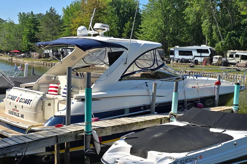  Yacht Photos Pics 2003 Regal Commodore 4260 yacht docked at a marina with lush green surroundings.