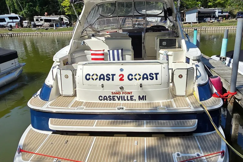  Yacht Photos Pics 2003 Regal Commodore 4260 boat docked, featuring "Coast 2 Coast" signage, Caseville, MI.