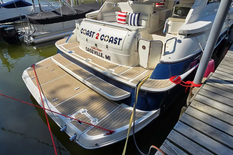  Yacht Photos Pics 2003 Regal Commodore 4260 yacht docked, featuring spacious deck and striped cushions.