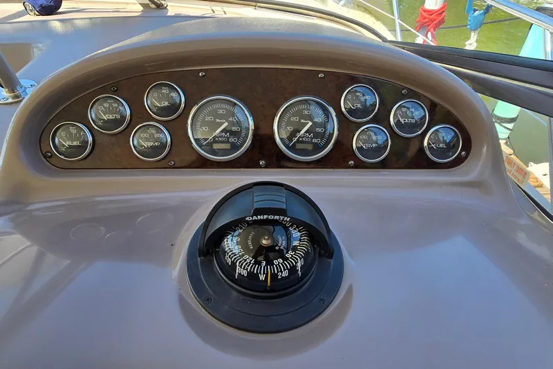  Yacht Photos Pics Dashboard of a 2003 Regal Commodore 4260 boat with gauges and compass.