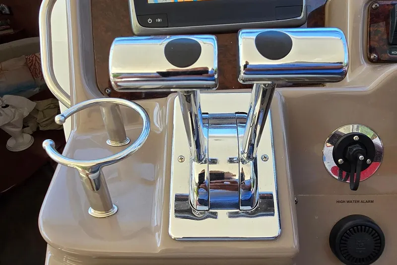  Yacht Photos Pics Control panel of a 2003 Regal Commodore 4260 boat with throttle levers and high water alarm.