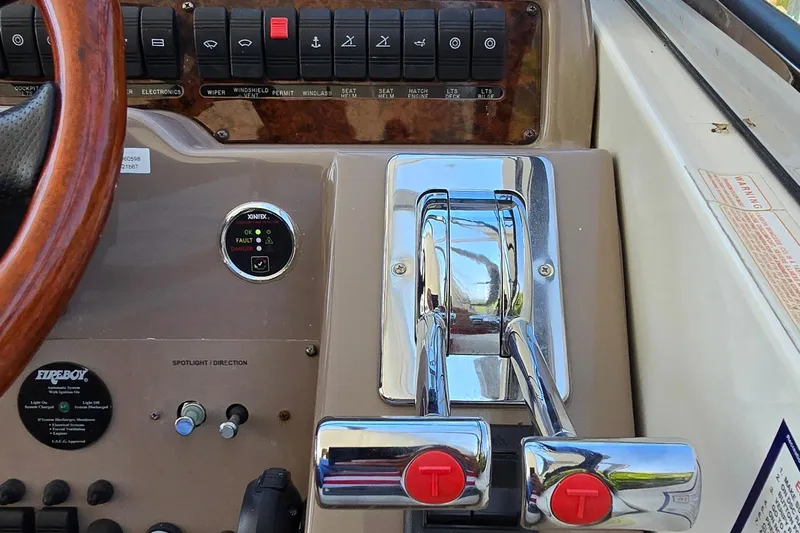  Yacht Photos Pics Control panel of a 2003 Regal Commodore 4260 boat with chrome throttle levers.