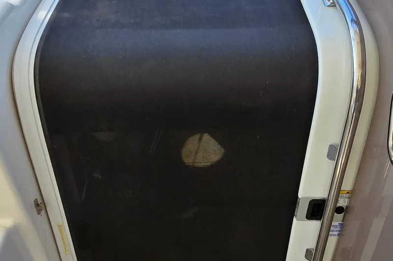  Yacht Photos Pics 2003 Regal Commodore 4260 boat door with black screen and metal frame.