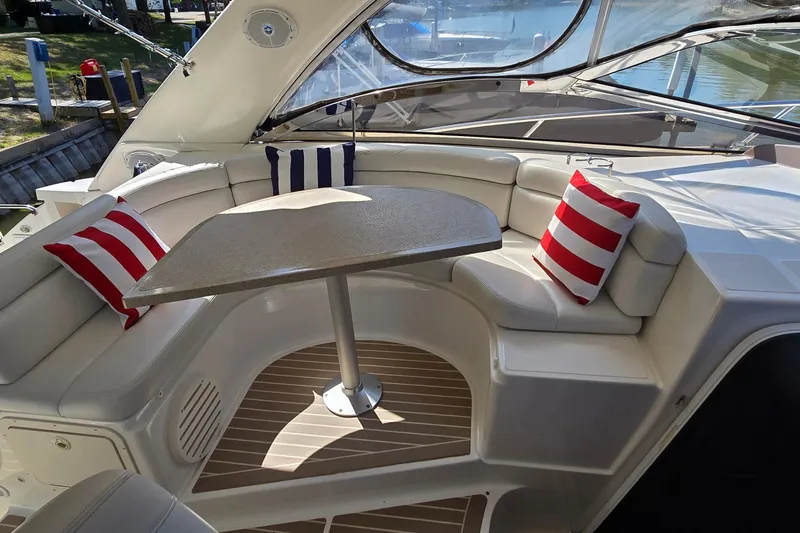  Yacht Photos Pics Luxurious seating area on 2003 Regal Commodore 4260 yacht with striped cushions and table.