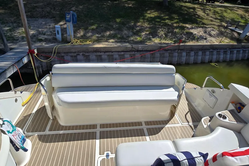  Yacht Photos Pics 2003 Regal Commodore 4260 boat interior with white seating and dockside view.