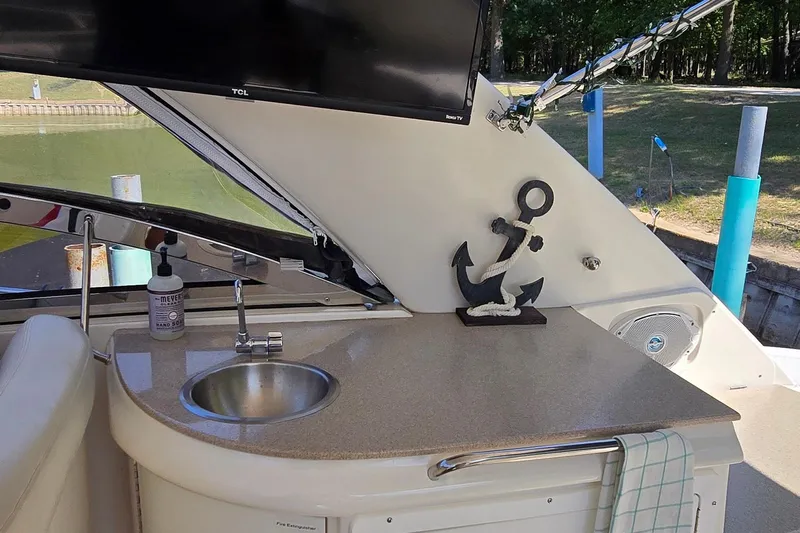  Yacht Photos Pics 2003 Regal Commodore 4260 yacht interior with sink, anchor decor, and TV.