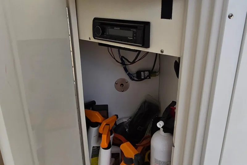  Yacht Photos Pics Storage compartment in a 2003 Regal Commodore 4260 with stereo and cleaning supplies.