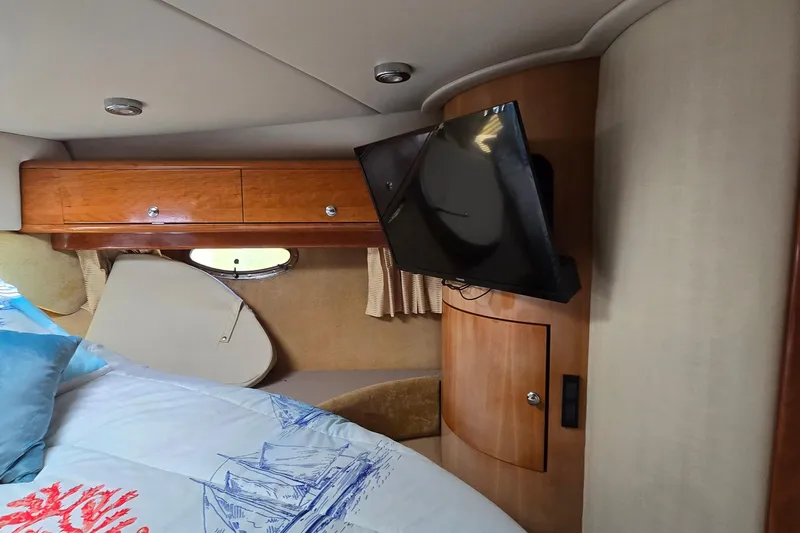  Yacht Photos Pics Interior of 2003 Regal Commodore 4260 yacht with TV and wooden cabinetry.