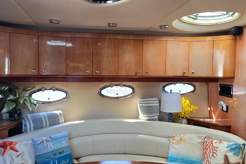  Yacht Photos Pics Luxurious interior of 2003 Regal Commodore 4260 yacht with elegant wood cabinets and cozy seating.