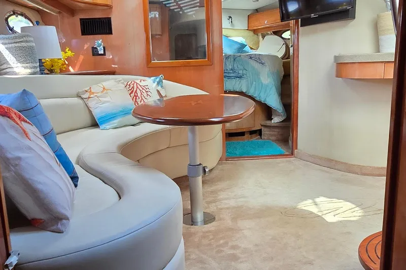  Yacht Photos Pics Luxurious interior of 2003 Regal Commodore 4260 yacht with cozy seating and elegant decor.