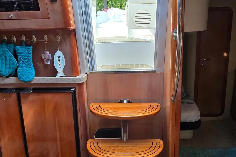 Yacht Photos Pics Interior of 2003 Regal Commodore 4260 yacht with wooden steps and teal oven mitts.