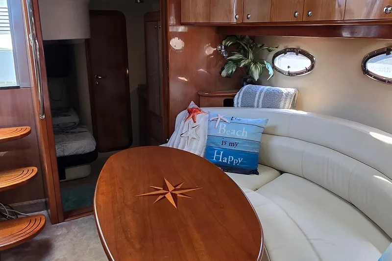  Yacht Photos Pics 2003 Regal Commodore 4260 yacht interior with cozy seating and nautical decor.