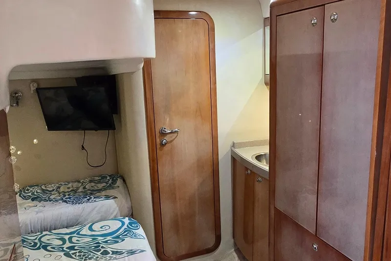  Yacht Photos Pics 2003 Regal Commodore 4260 cabin interior with wood finish, twin beds, and TV.