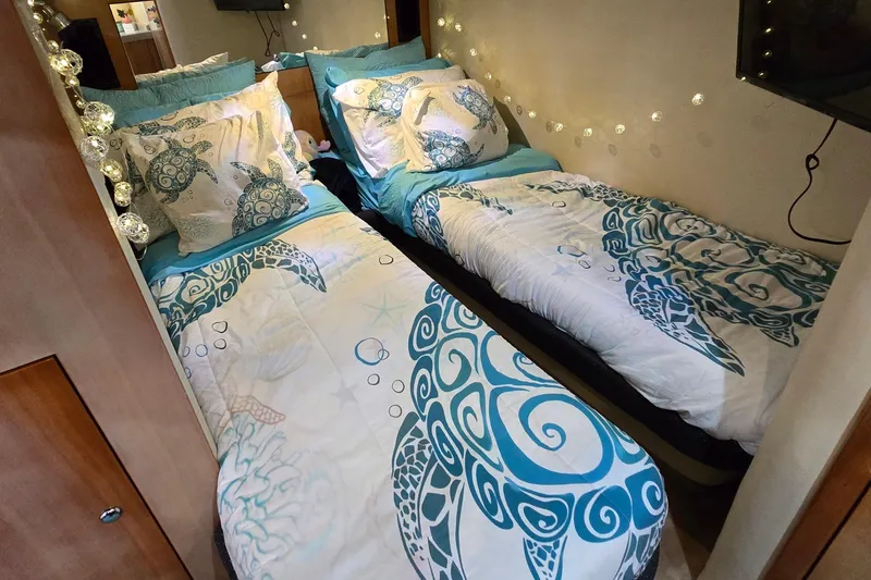  Yacht Photos Pics Twin beds with turtle-themed bedding in a 2003 Regal Commodore 4260 cabin.