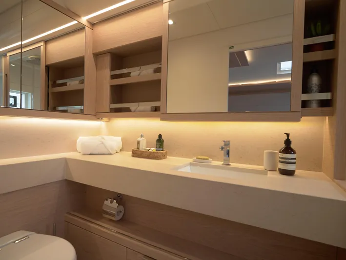 Kajikia Yacht Photos Pics Luxurious bathroom interior of 2023 Lagoon 77 yacht with modern fixtures and elegant design.
