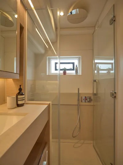 Kajikia Yacht Photos Pics Luxurious bathroom in 2023 Lagoon 77 yacht with modern shower and sleek design.