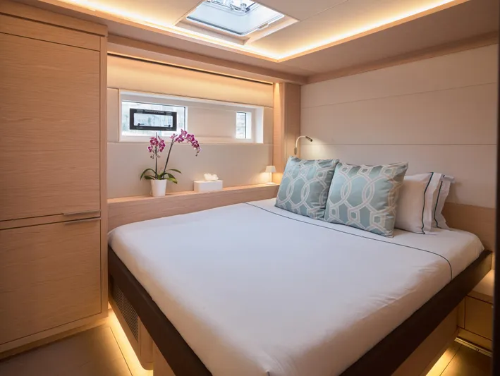Kajikia Yacht Photos Pics Luxurious bedroom interior of 2023 Lagoon 77 yacht with modern design and elegant lighting.