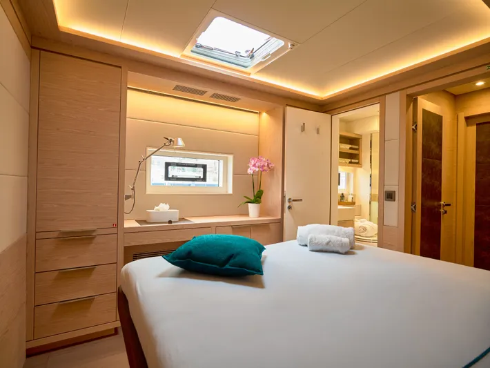 Kajikia Yacht Photos Pics Luxurious bedroom interior of 2023 Lagoon 77 yacht with modern design and ambient lighting.