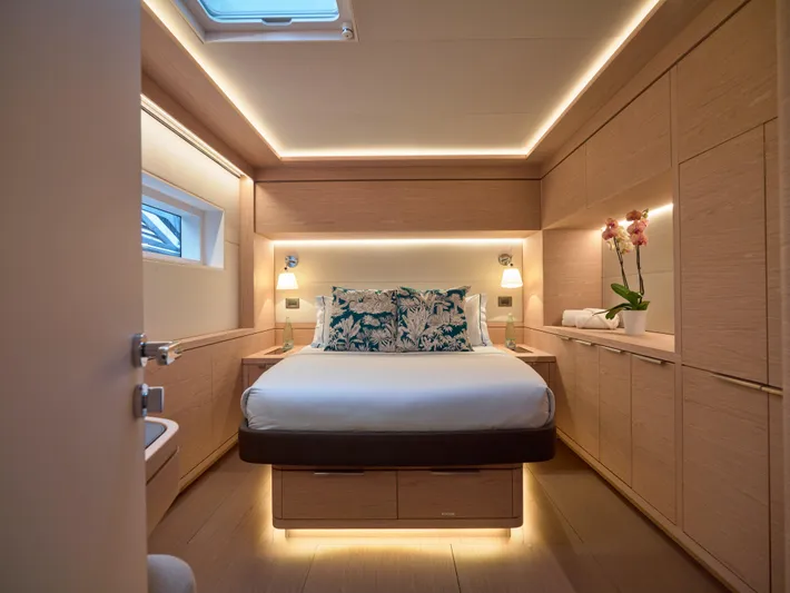 Kajikia Yacht Photos Pics Luxurious bedroom interior of 2023 Lagoon 77 yacht with modern lighting and elegant decor.