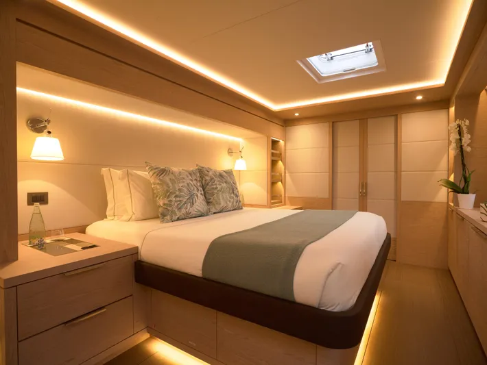 Kajikia Yacht Photos Pics Luxurious bedroom interior of 2023 Lagoon 77 yacht with modern lighting and elegant decor.