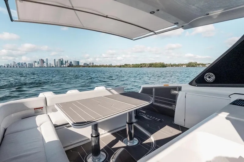  Yacht Photos Pics 2025 Azimut Verve 42 yacht interior with city skyline view, featuring sleek seating and table.