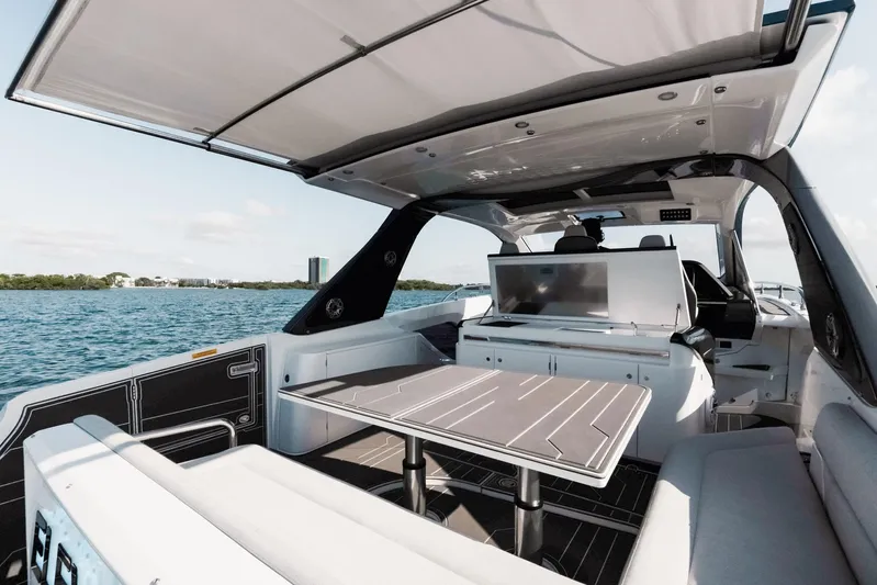  Yacht Photos Pics Luxurious 2025 Azimut Verve 42 yacht interior with sleek seating and table, overlooking serene waters.