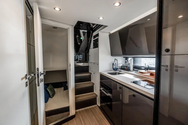  Yacht Photos Pics Modern kitchen interior of 2025 Azimut Verve 42 yacht, featuring sleek cabinetry and appliances.
