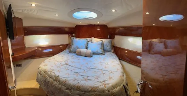 Everything 4 Sail Yacht Photos Pics Luxurious cabin interior of 2006 Princess 58v yacht with cozy bedding and elegant wood finish.