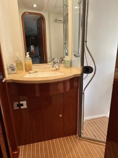 Everything 4 Sail Yacht Photos Pics Luxurious bathroom in 2006 Princess 58v yacht with modern fixtures and wooden accents.