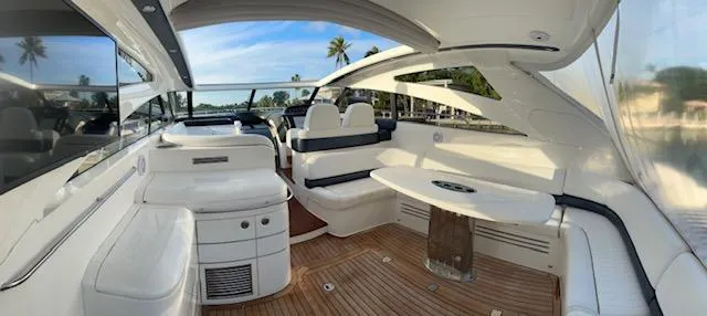 Everything 4 Sail Yacht Photos Pics Luxurious 2006 Princess 58v yacht interior with white seating and wooden flooring.