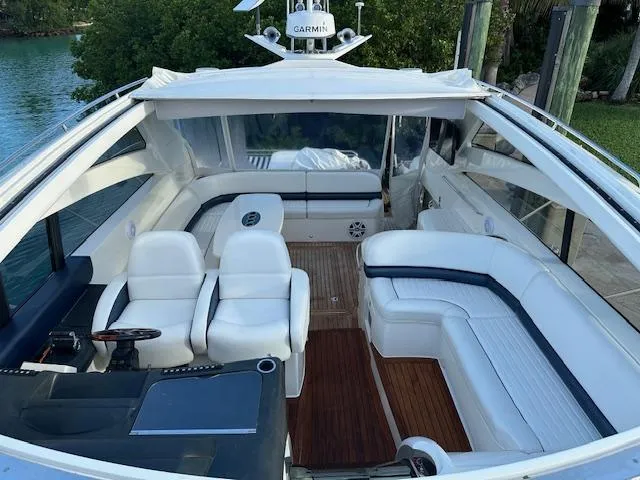 Everything 4 Sail Yacht Photos Pics Luxurious 2006 Princess 58v yacht interior with white seating and wooden flooring.