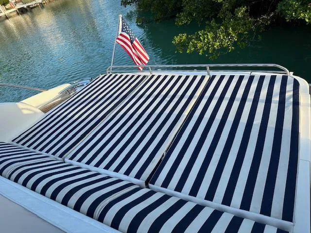 Everything 4 Sail Yacht Photos Pics Striped sunbathing deck on 2006 Princess 58v yacht with American flag.