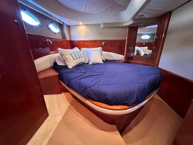 Everything 4 Sail Yacht Photos Pics Luxurious cabin interior of 2006 Princess 58v yacht with cozy bed and elegant wood finish.