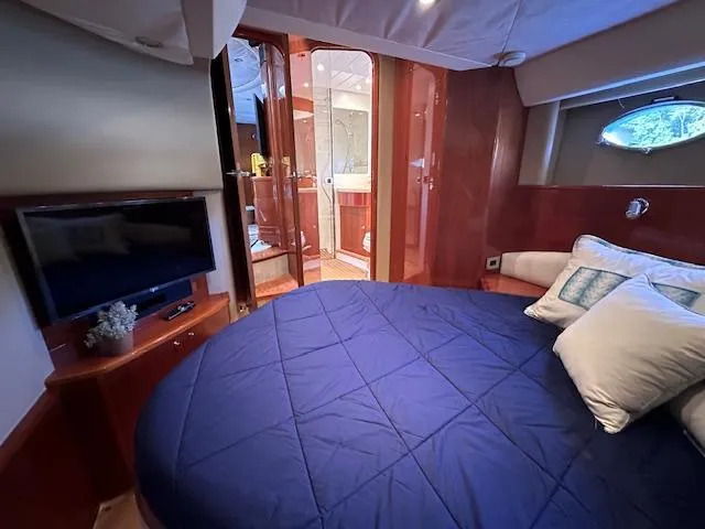 Everything 4 Sail Yacht Photos Pics Luxurious cabin interior of 2006 Princess 58v yacht with cozy bedding and TV.