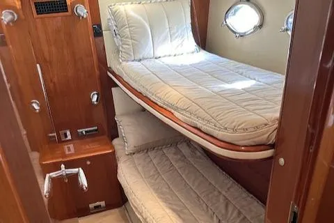 Everything 4 Sail Yacht Photos Pics 2006 Princess 58v yacht cabin with bunk beds and porthole windows.