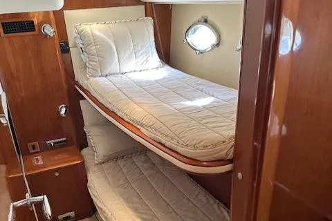 Everything 4 Sail Yacht Photos Pics Interior cabin of 2006 Princess 58v yacht with twin beds and wooden finish.