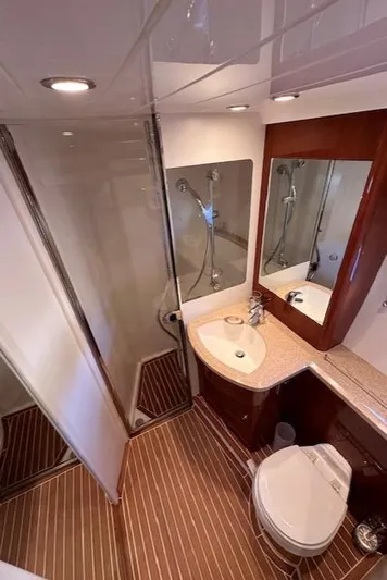 Everything 4 Sail Yacht Photos Pics Luxurious bathroom in 2006 Princess 58v yacht with modern fixtures and wood accents.