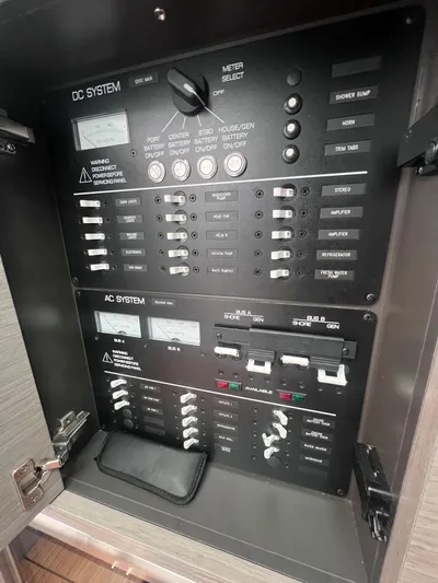  Yacht Photos Pics Electrical control panel on a 2023 Tiara Yachts 38 LS, featuring DC and AC systems.