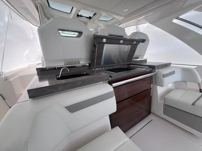  Yacht Photos Pics 2023 Tiara Yachts 38 LS interior with modern kitchen and seating area.